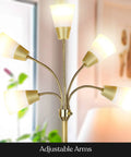 Lit Five Head LED Floor Lamp for Living Rooms and Offices with Interchangeable Shade and Brass Finish illuminated indoors.