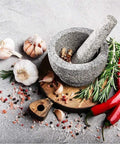 Large Granite Mortar And Pestle Set With 2 Cup Capacity Lid Silicone Lid Garlic Peeler And Anti Slip Base Pad Unpolished Granite Spice Grinder For Grinding Herbs And Spices Kitchen Must Have with herbs and spices on a wooden board