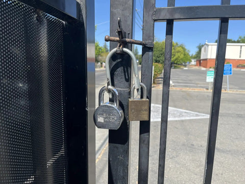 Super Secure Dual Padlock Gate Lock Killing Messy Daisy Chains For Hella Tough Barn Yard Protection Letting Two Different Property Owners Use Their Own Separate Keys on a gated entrance.