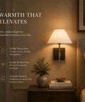 DANCYHOME Modern Farmhouse Weathered Bronze Cordless Wall Sconce casting a warm 2700K glow beside a cozy bedside table.