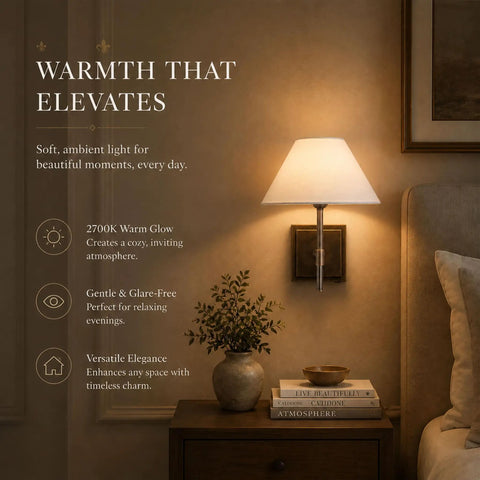 DANCYHOME Modern Farmhouse Weathered Bronze Cordless Wall Sconce casting a warm 2700K glow beside a cozy bedside table.