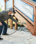 Man using Heavy Duty Mobile Airless Paint And Stain Sprayer Cart for smooth finishes on wooden steps.