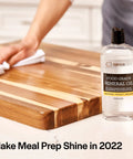Person applying Food Grade Mineral Oil For Wood Cutting Boards, Countertops, And Butcher Blocks to a wooden surface.
