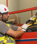 Worker using Adjustable Non-Shock Absorbing Lanyard 4 To 6 Feet Yellow For Fall Protection And Work At Heights in industrial setting.