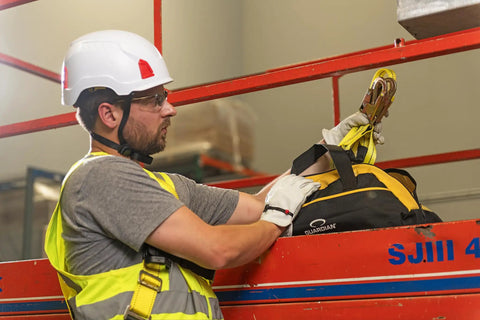 Worker using Adjustable Non-Shock Absorbing Lanyard 4 To 6 Feet Yellow For Fall Protection And Work At Heights in industrial setting.