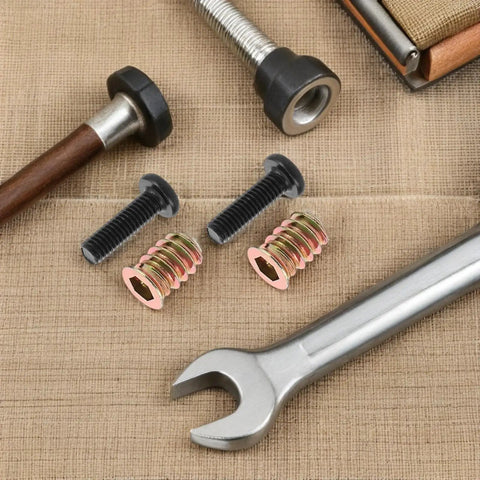 Metal Threaded Inserts Kit For Wood Furniture Assembly With Wrenches And Drill Bit Screw In Fasteners close-up on burlap