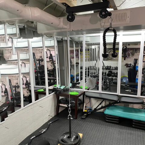 Ceiling Mount Gym Pulley System Stand With Preinstalled Pulleys For DIY Home Gym Or Garage LAT Pulldown And Squat Rack Attachment 16 Inch Hole Spacing installed in gym.