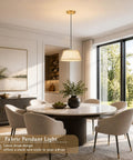 AyshwillDec 10" Modern Gold Linen Pendant Light Dining Room Bulb Included hanging over a round dining table with soft chairs.