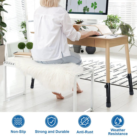 Heavy Duty Four Pack Folding Table Risers And Adjustable Height Leg Extenders For Bent Or Straight Furniture Legs being used on a desk with a person working.