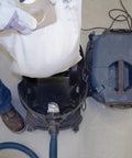 Person inserting VB140F 5 Pack 14 Gallon White Fleece Filter Bags For Dust Extractor VAC140 into vacuum for dust filtration
