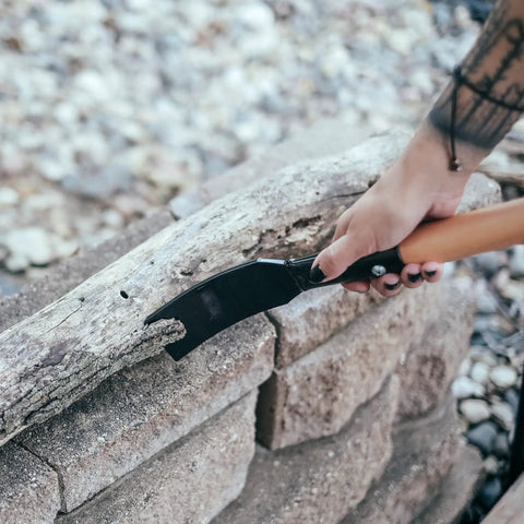 Bark Debarking Tool For Logs With Beveled Blade Easy Log Peeler Bark Remover Debarker Tool in use on wood outdoors