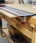Milescraft 1409 track saw guide, aluminum track with red edge, clamped to wooden workbench