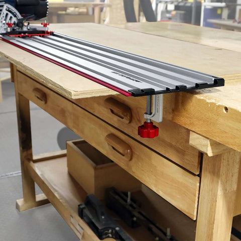 Milescraft 1409 track saw guide, aluminum track with red edge, clamped to wooden workbench