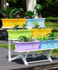Four Pack Rectangular Window Flower Box Planters With Trays For Balcony Windowsill Garden Durable Eco Friendly Plastic Great For Flowers Herbs And Small Vegetables 16.8 Inch Long, displayed on a balcony with plants