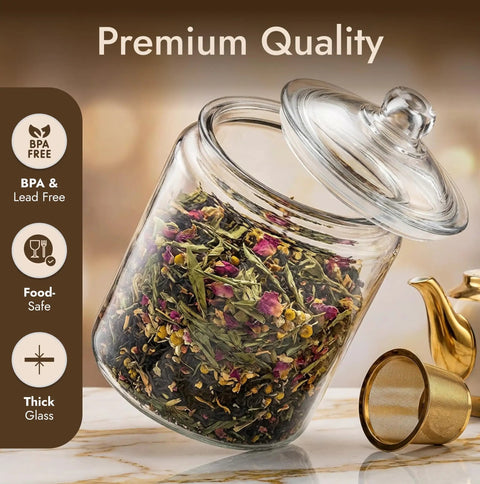 One Gallon Glass Cookie Jar with Airtight Lid for Cookies Candy Flour and Dog Treats, filled with tea leaves, on a counter