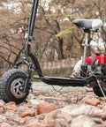 Off-road scooter with 3.00-4 tires and inner tubes, TR87 valve stem, shown in rocky terrain