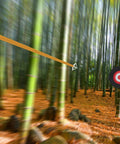 Round EVA Foam Arrow Target For Archery Training in bamboo forest with arrow in flight toward target