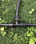 Three Way Lock Tee Barbed Irrigation Fittings For Half Inch Tubing installed on garden hose in grass
