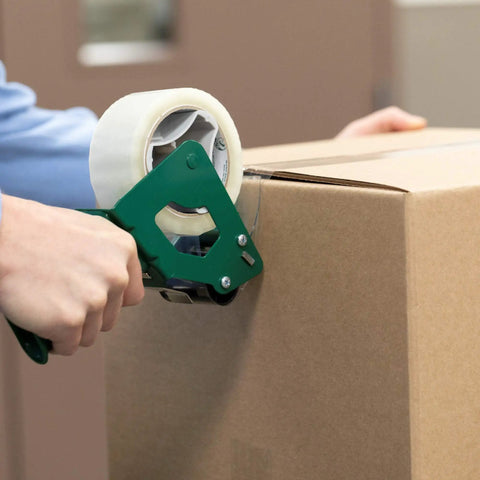 Using a dispenser to seal a box with Stock Up On These Super Useful Extra Long Clear Packing Tape Rolls Perfect For Shipping Mailing And Moving Projects Comes As A Set Of Four One Point Eight Eight Inch By One Hundred Yard Rolls With Three Inch Cores For Easy Dispensing.