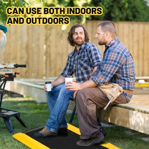 Two men sitting on a Heavy Duty Anti Fatigue Floor Mat 2x3 Ft Diamond Plate Vinyl Non Slip Ergonomic Standing Pad for Workshop Black With Yellow Border Seven Eighths Inch Thick Sponge Cushion Comfort outdoors with tools.