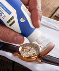 Hand using rotary tool from 357 Piece Rotary Tool Accessories Kit with One Eighth Inch Shanks to polish a watch face.