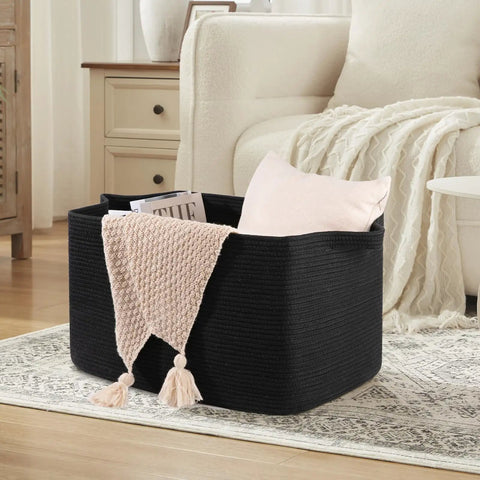 95L Extra Large Blanket Basket For Living Room And Nursery 24 By 16.9 By 14.2 Inch Woven Storage Bin Perfect For Blankets Toys Towels And Dirty Clothes Sturdy Rectangle Organizer In Black filled with pillows and blanket