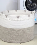 Huge Boho Blanket Basket 22 By 22 By 16 Inches Cotton Rope Storage Hamper For Throws Pillows Towels And Laundry Foldable Durable Decorative Round Organizer For Living Room Brown in front of a washing machine.