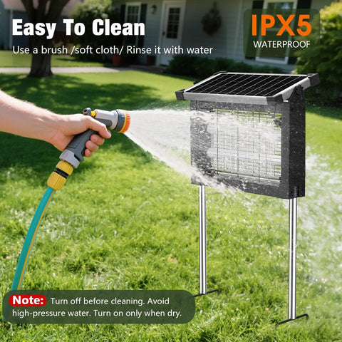 Cordless Outdoor Solar Bug Zapper With 4500V Grid Waterproof Mosquito Killer being cleaned with a hose in a yard setup