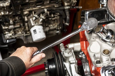 Using Half Inch Drive 84 Tooth Teardrop Ratchet with 15 Inch Long Handle on engine, showcasing enclosed head and polish chrome finish.