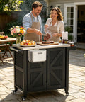 Outdoor Grill Cart With Stainless Steel Tabletop And Storage Cabinet in use at a backyard BBQ with four wheels and folding trash can