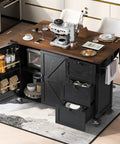 54 Inch Farmhouse Kitchen Cart Featuring A Nifty Power Outlet And Hefty Storage Space With Smooth Rolling Lockable Wheels And Sleek Black Finish, shown in modern kitchen setup with storage.