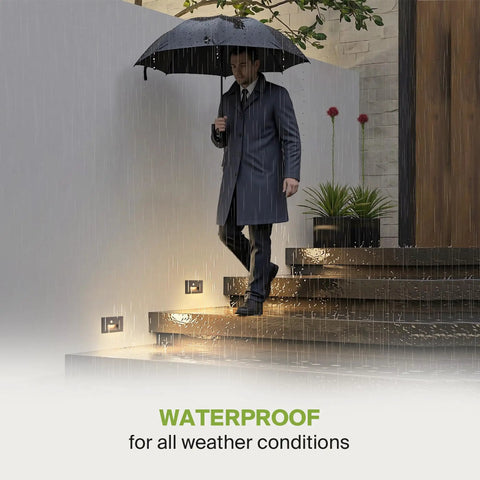 Man with umbrella on wet stairs lit by Hardwired Recessed Stair Step Light Kit For Indoor Outdoor Use 3CCT (3000K-5000K) Motion Sensor Waterproof ETL Listed 3W 120LM Black Finish 4 Pack Ideal For Architectural Stairs And A Safe Soft Glow For Hallways