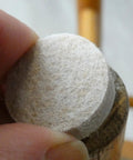 Applying a 1 Inch Round Self Adhesive Felt Furniture Slider for Hard Floors Leveling Pads to a chair leg to stop scratches