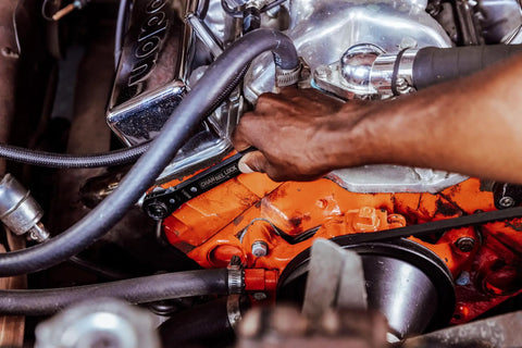Mechanic using 8-In-1 SAE Ratcheting Wrench Set In Two Pieces With Hollow Sockets And Double Box End Design Includes 5/16 3/8 7/16 9/16 5/8 11/16 3/4 Inch 12 Point Ratchet Heat Treated For Durability Made In USA on engine