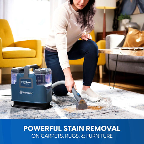 Person using Portable Carpet And Upholstery Spot Cleaner With SixFoot Hose For Deep Stain Busting on carpet in living room