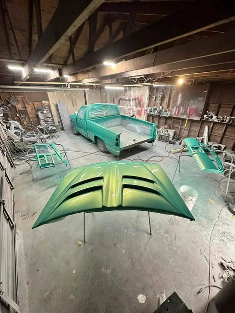 Rich Jade Green Basecoat Paint Gallon Drop In Ready To Spray With Included Fast Dry Reducer applied to truck parts in a workshop.