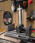 4 Inch Drill Press Vise Beefy Heavy Duty Solid Cast Iron Bench Vise With V Groove Jaws For Precision Drilling In Metalworking And Woodworking Rock Solid Stability Smooth Guide Rails And Easy One Hand Clamp, holding drill bit on bench