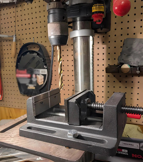4 Inch Drill Press Vise Beefy Heavy Duty Solid Cast Iron Bench Vise With V Groove Jaws For Precision Drilling In Metalworking And Woodworking Rock Solid Stability Smooth Guide Rails And Easy One Hand Clamp, holding drill bit on bench