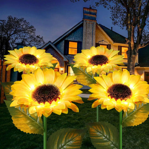 Upgraded 4 Flower Solar Sunflowers With Fairy Light Petals For Yard Decor illuminating a yard at night
