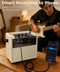 Musician using Mini Electric Guitar Amplifier With OTG Recording For Content Creators connected to a phone, cream white
