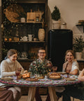 Group dining around a table with a fitted round tablecloth waterproof vinyl circle cover fits 36 to 44 inch tables indoor