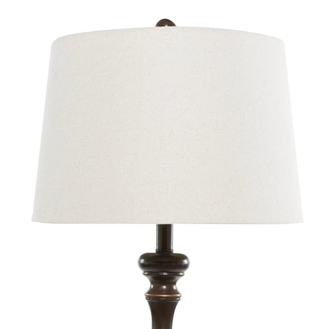 Close-up of cream drum shade and polystone base from Polystone Floor Lamps Set Of 3 With Drum Shades In Brown Finish, Traditional Trapezoid Silhouette, One Tall 61 Inch And Two 30 Inch Lamps, Cream Linen Shade, Solid Polystone Construction For Classic Living Rooms.