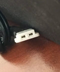 Close-up of Dual Pack USB Charging Cable Replacement For DX5 Drone Plug And Play Charger Cord connector on wooden surface.