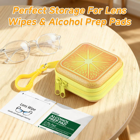 Lens-wipe carrying case: yellow square tin with orange slice lid, zipper and clip, shown with glasses.