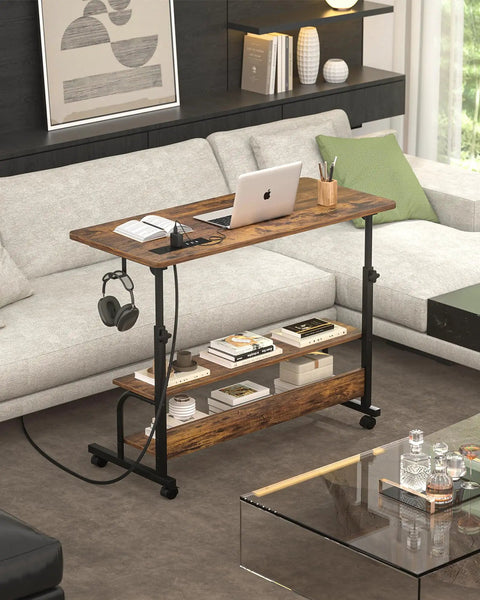Rolling Standing Desk With Power Outlets And USB Ports, 32 Inch Manual Height Adjustable Mobile Computer Desk On Wheels next to sofa