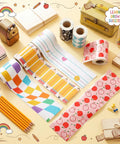 Six Back To School Bulletin Board Borders Set 198 Feet Total with 2.36 Inch Wide Rolls displayed on a desk with decor.