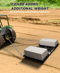 Heavy Duty Tow Behind Workhorse Harrow Rake For Driveways And Lawns shown attached to tractor with added weight