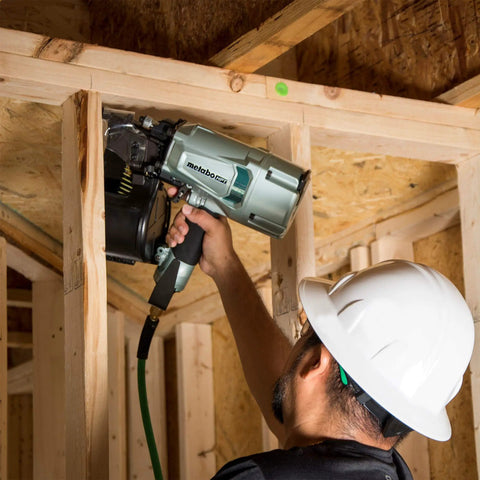 Worker using Coil Framing Nailer With 15 Degree Magazine Delivers Fast Driving For Two Inch To Three And One Quarter Inch Nails