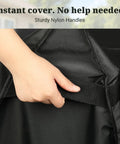Hand holding Built To Last Heavy Duty Outdoor Prep Table Cover for Unity XL showing sturdy nylon handles.