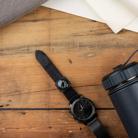 Slip On Wrist Compass For Survival Gear And Outdoor Adventurers, Easy Read Back Up Nav Tool on black watch band on wood surface